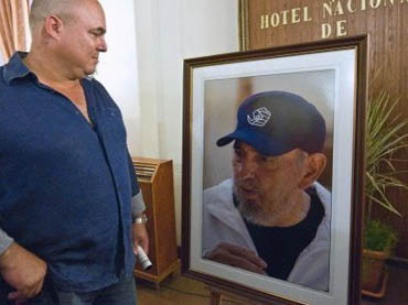 Alex, hijo de Fidel, frente a su foto
